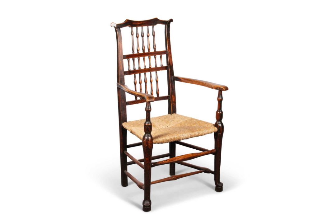 AN EARLY 19TH CENTURY LANCASHIRE ASH AND ELM SPINDLE-BACK ARMCHAIR