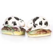 A NEAR PAIR OF STAFFORDSHIRE POTTERY MODELS OF RABBITS, 19TH CENTURY