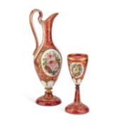 A 19TH CENTURY BOHEMIAN GILDED AND PAINTED RUBY GLASS EWER AND GOBLET