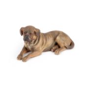 AN AUSTRIAN PAINTED TERRACOTTA MODEL OF A RECUMBENT DOG