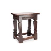 AN ANTIQUE JOINED OAK STOOL