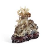 A CHINESE BLACK AND WHITE JADE 'MYTHICAL BEAST' VASE AND COVER