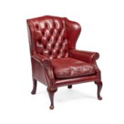 A GEORGIAN STYLE DEEP-BUTTONED RED LEATHER WING-BACK ARMCHAIR