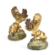 A PAIR OF 19TH CENTURY PAINTED TERRACOTTA MODELS OF LIONS RAMPANT