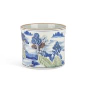 A CARVED UNDERGLAZE-BLUE, COPPER-RED AND CELADON-GLAZED 'LANDSCAPE' BRUSH POT, BITONG