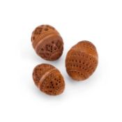 THREE PIERCED AND CARVED COQUILLA NUTS