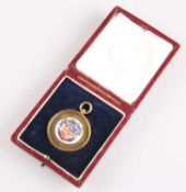A GEORGE V SILVER-GILT AND ENAMEL 'HARROGATE' FOB MEDALLION