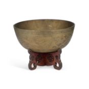 A CHINESE BRASS BOWL ON STAND