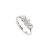 A PLATINUM, 18 CARAT WHITE GOLD AND DIAMOND THREE STONE RING