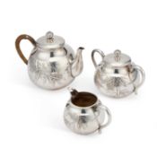 AN EARLY 20TH CENTURY JAPANESE SILVER THREE-PIECE TEA SERVICE