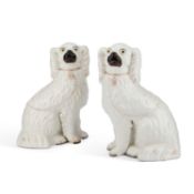 A PAIR OF VICTORIAN STAFFORDSHIRE POTTERY MODELS OF SEATED SPANIELS
