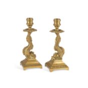 A PAIR OF BRASS 'DOLPHIN' CANDLESTICKS