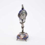 AN AUSTRIAN SILVER AND ENAMEL FIGURAL STANDING CLOCK