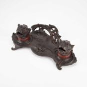 A FRENCH PATINATED METAL INKSTAND, CIRCA 1900