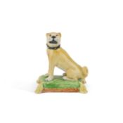 A 19TH CENTURY POTTERY MODEL OF A SEATED PUG