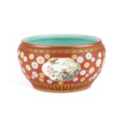 A CHINESE FAMILLE ROSE ENAMELLED CORAL-RED GROUND JARDINIÈRE