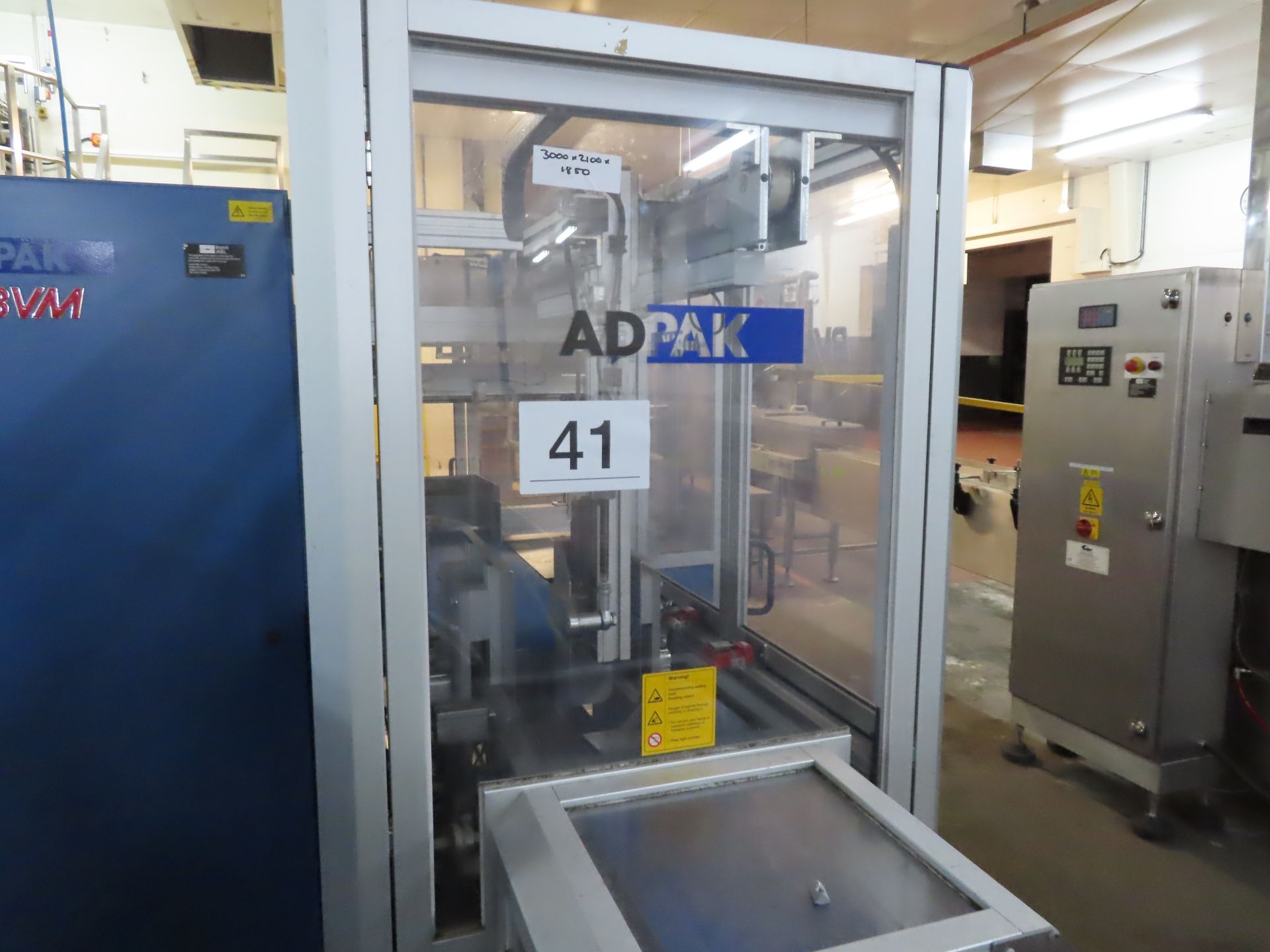 1 x Adpak BVM sleeve wrapping machine. The unit stacks product and ...