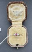 Jewellery: An 18ct yellow gold ring set with a ruby flanked by two old cut diamonds, UK size P, 2.6g