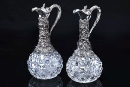 A PAIR OF VICTORIAN SILVER MOUNTED CUT GLASS CLARET JUGS
