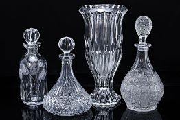 A GROUP OF THREE CUT GLASS DECANTERS AND A VASE