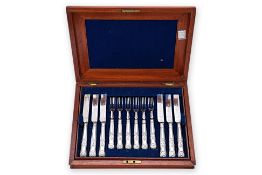 A SET OF VICTORIAN SILVER PLATED FRUIT KNIVES AND FORKS