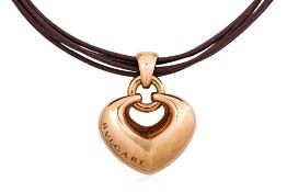 A HEART PENDANT ON A MULTI STRAND LEATHER CORD BY BVLGARI
