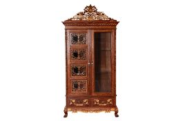 A CARVED AND PARCEL GILT TEAK CABINET