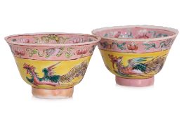TWO FAMILLE ROSE YELLOW GROUND TEA BOWLS