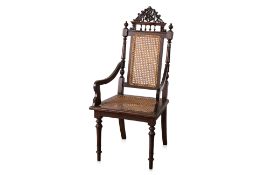 A CARVED AND CANED OPEN ARMCHAIR