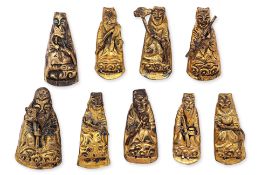 A SET OF NINE SILVER-GILT HAT MOUNTS