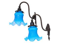 A PAIR OF WALL SCONCES WITH BLUE GLASS SHADES
