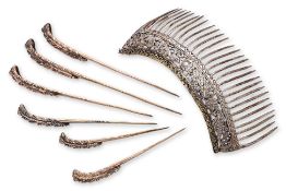 A SET OF SIX SILVER-GILT HAIR PINS AND A HAIR COMB