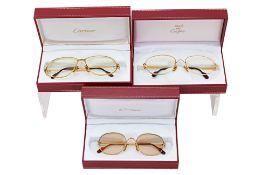 THREE PAIRS OF CARTIER GLASSES
