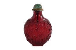 A DARK CHERRY-RED 'BUDDHIST OBJECTS' SNUFF BOTTLE