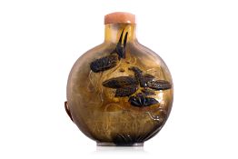 A RELIEF DECORATED AMBER GLASS SNUFF BOTTLE