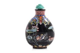 AN ENAMELLED BLACK GLASS 'LOTUS POND' SNUFF BOTTLE