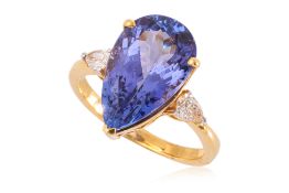 A TANZANITE AND DIAMOND THREE STONE RING.