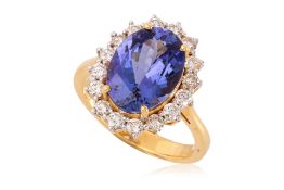 A TANZANITE AND DIAMOND 'HALO' RING