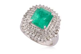 AN EMERALD AND DIAMOND 'TRIPLE HALO' RING