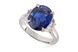 A VIVID BLUE SAPPHIRE AND DIAMOND THREE STONE RING