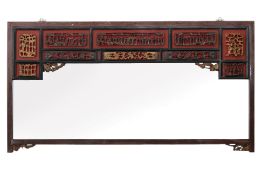 A LARGE CARVED AND GILT WALL MIRROR