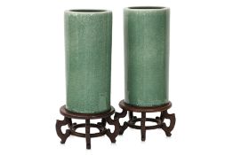 A PAIR OF CELADON GLAZED STICK STANDS