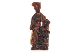 A RECONSTITUTED AMBER FIGURE OF LADY AND CHILD