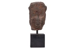 A SOUTHEAST ASIAN CARVED STONE HEAD OF A DEITY