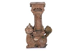 A VIETNAMESE STONEWARE CANDLEHOLDER WITH NGHE FORM BASE