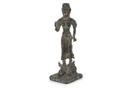 A SOUTHEAST ASIAN BRONZE SHIVA STANDING ON NANDI
