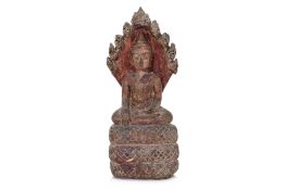 A SOUTHEAST ASIAN CARVED STONE NAGA BUDDHA