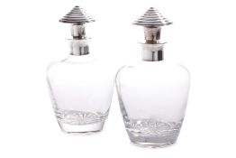 A PAIR OF CHRISTOFLE SILVER PLATE MOUNTED DECANTERS