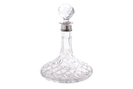 AN ENGLISH SILVER MOUNTED CUT GLASS SHIP'S DECANTER