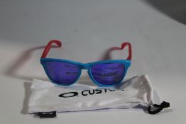 A pair of Oakley custom blue with purple/pink arms